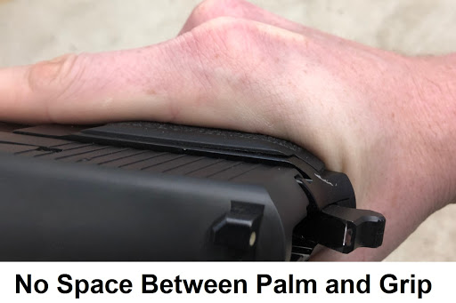 No space between palm and pistol grip.